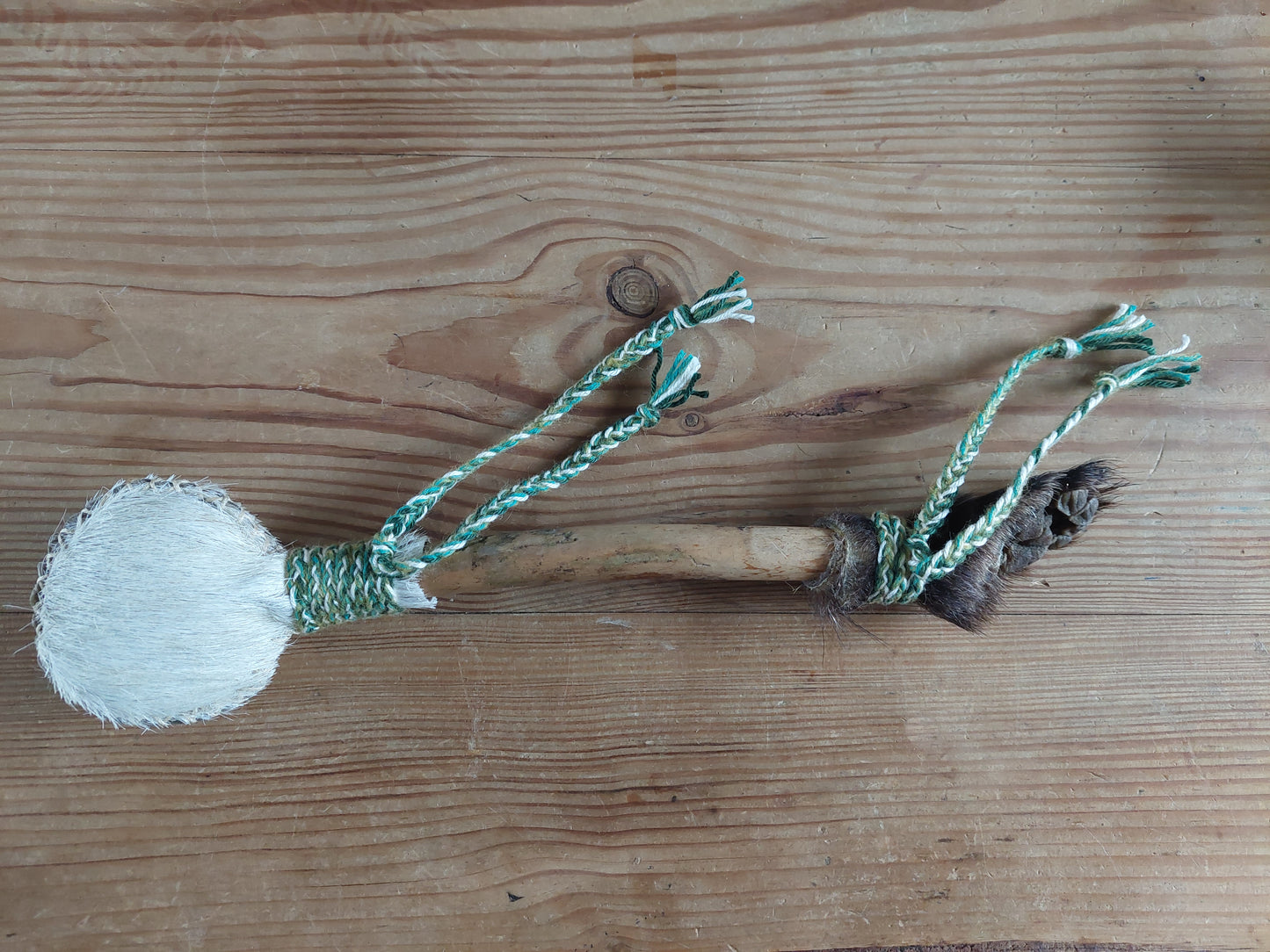 Horse hide, badger paw and pine wood rattle