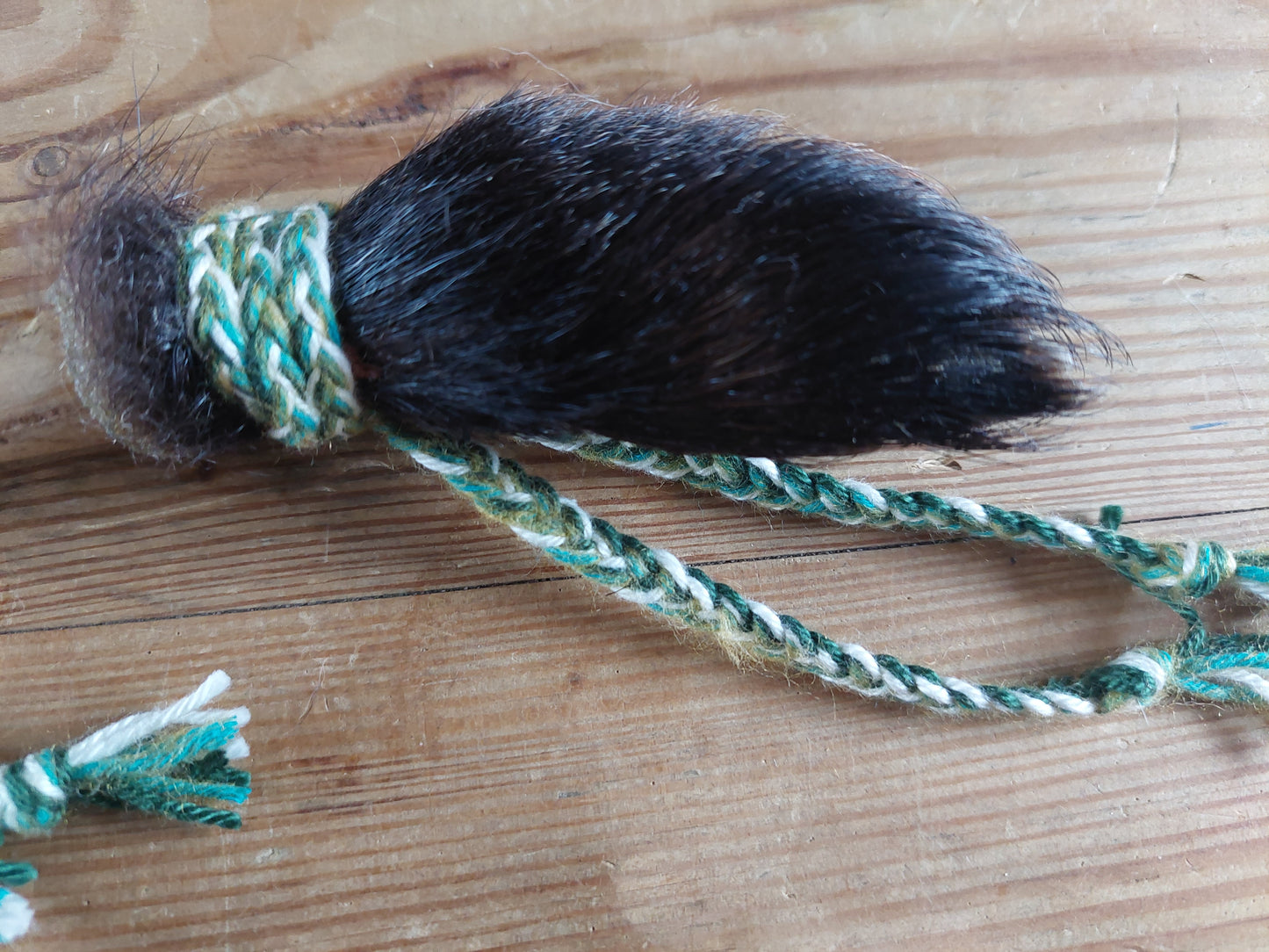 Horse hide, badger paw and pine wood rattle