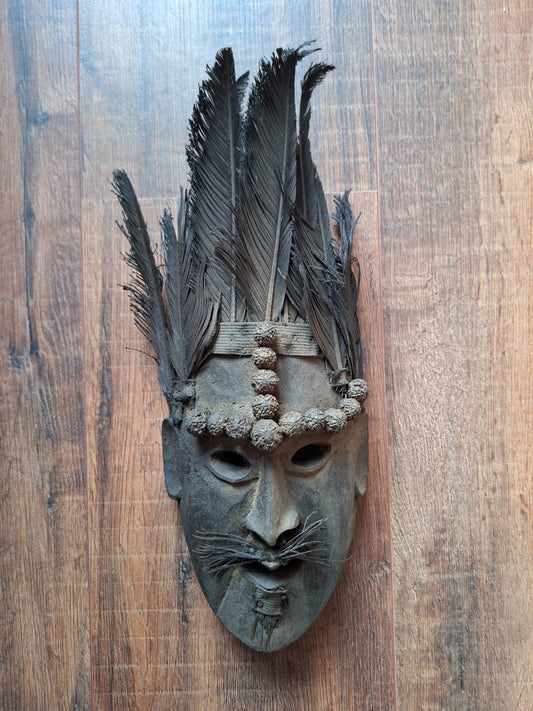 Antique Nepalese wooden mask with rudraksha and feathers