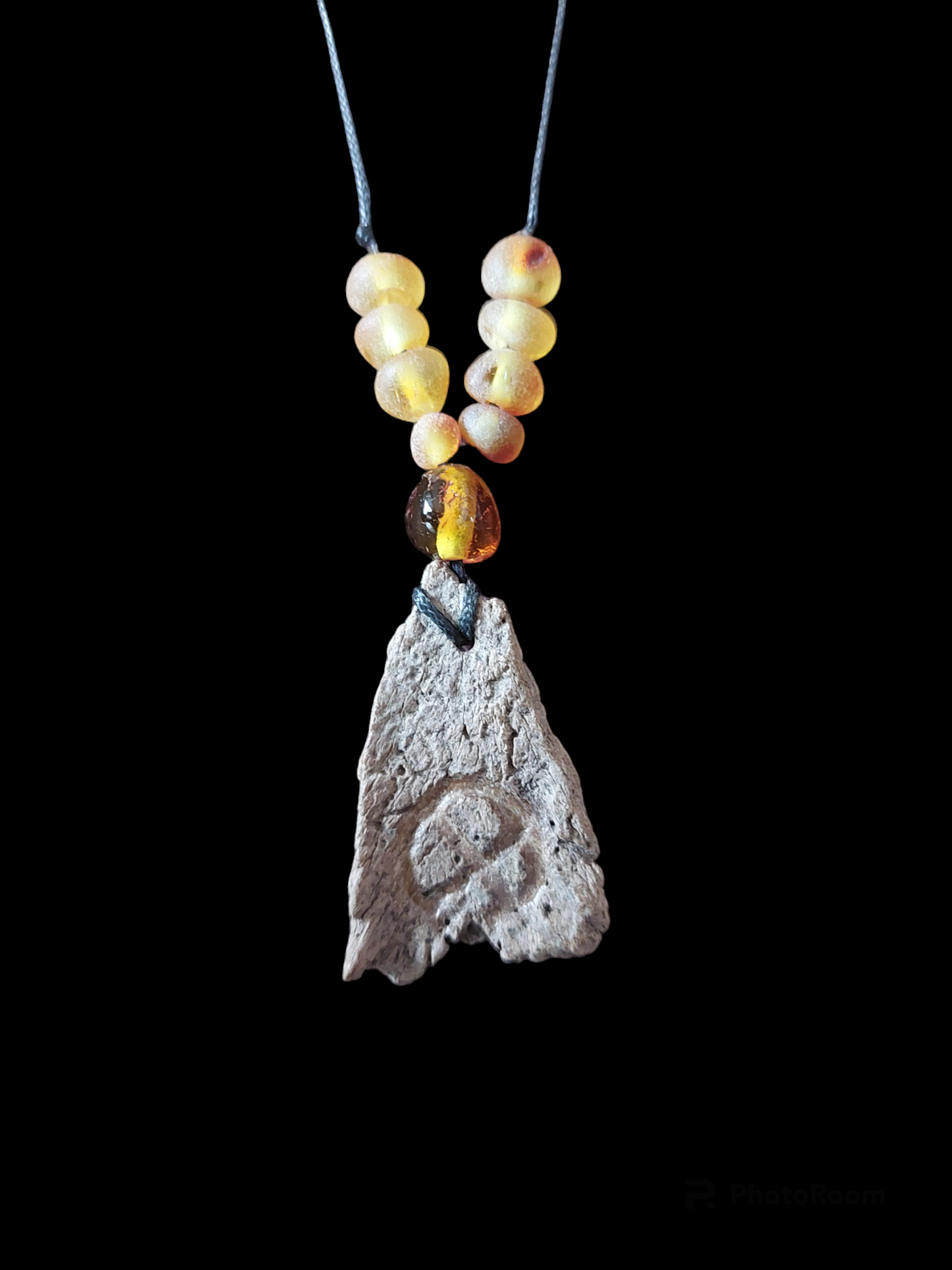 Engraved fossilized bone and amber amulet necklace #1