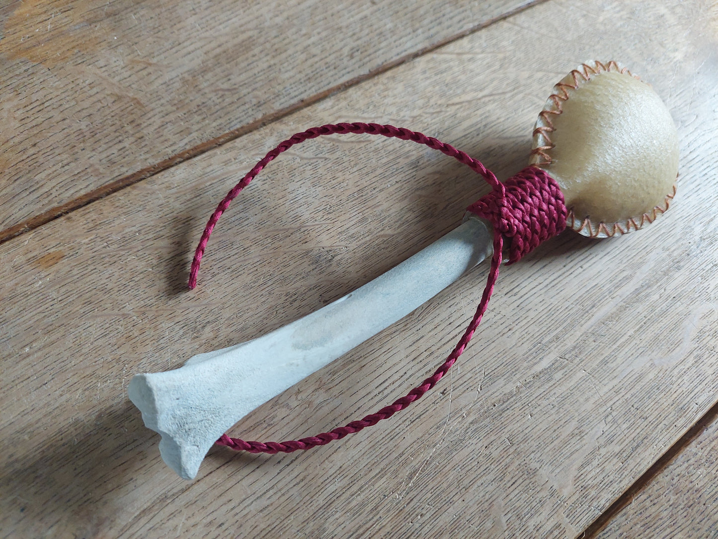 Red deer hide and roe deer leg bone rattle