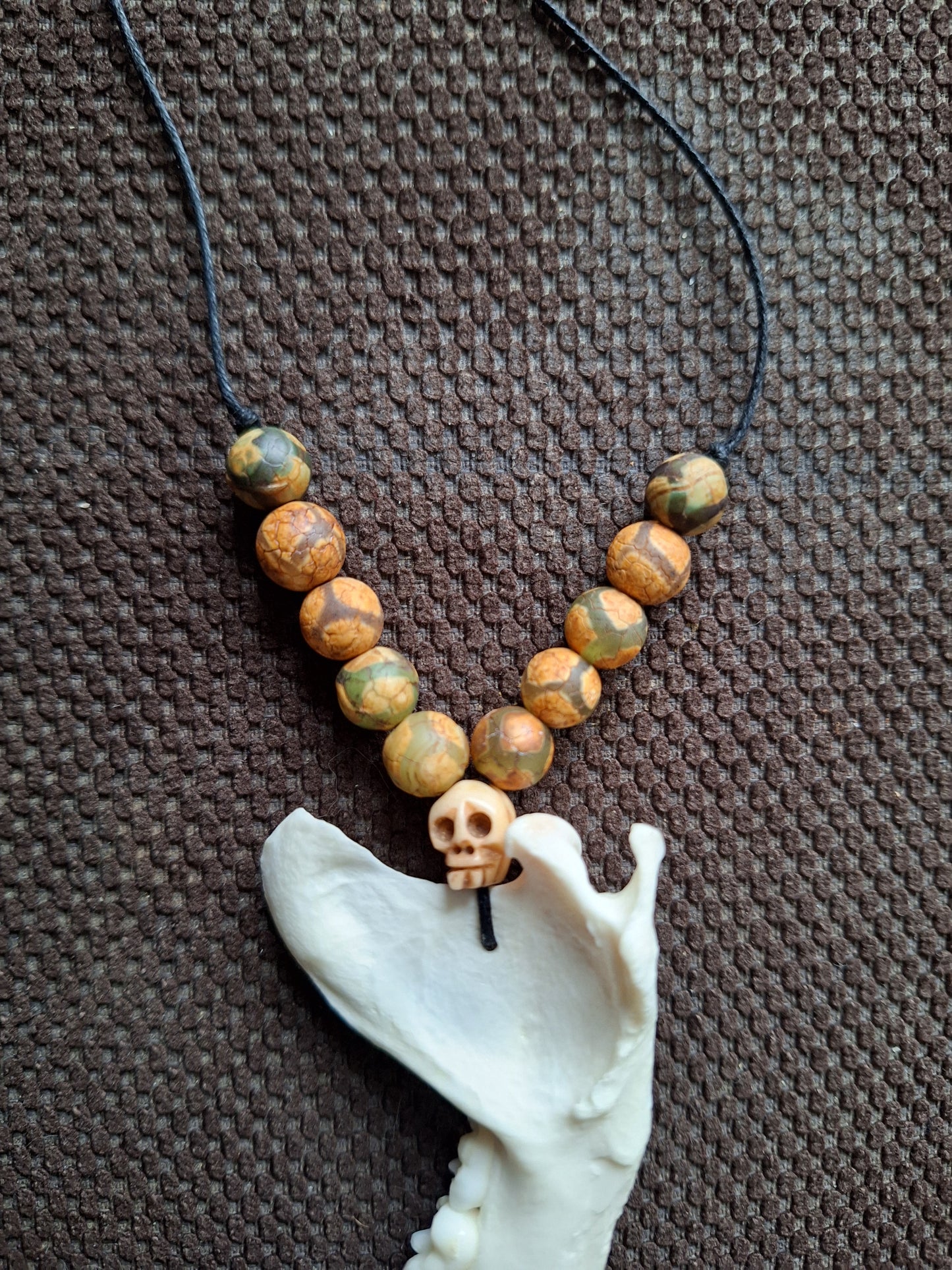 Racoon jaw bone with yak bone skull amulet necklace