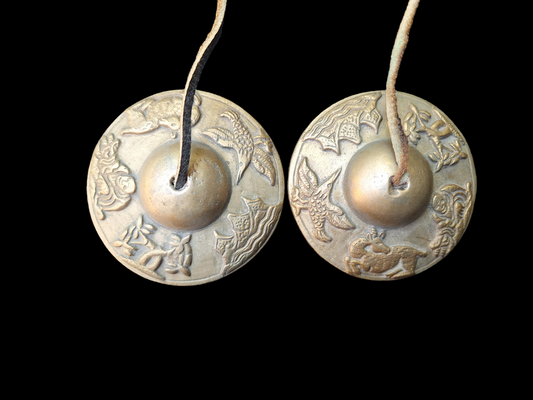 Vintage tingsha bells with buddhist symbols