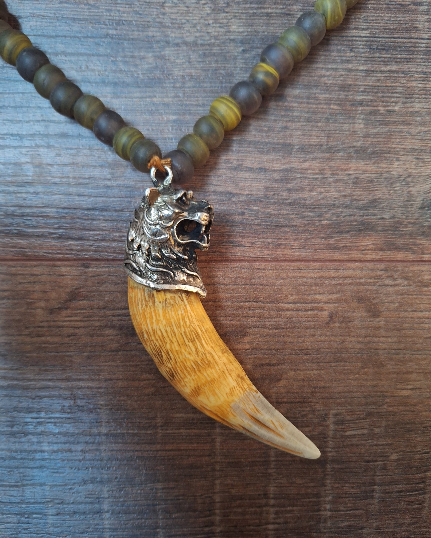 Vintage glass bead necklace with resin tiger tooth pendant