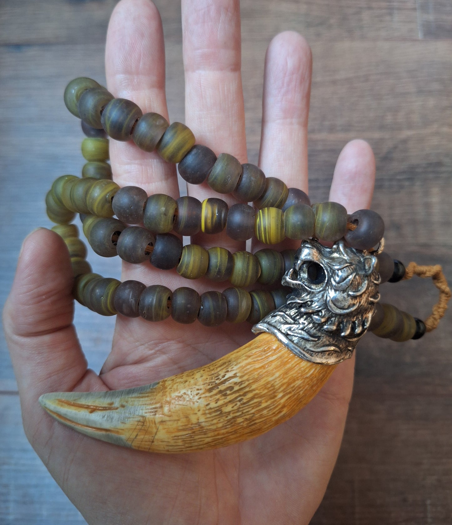 Vintage glass bead necklace with resin tiger tooth pendant