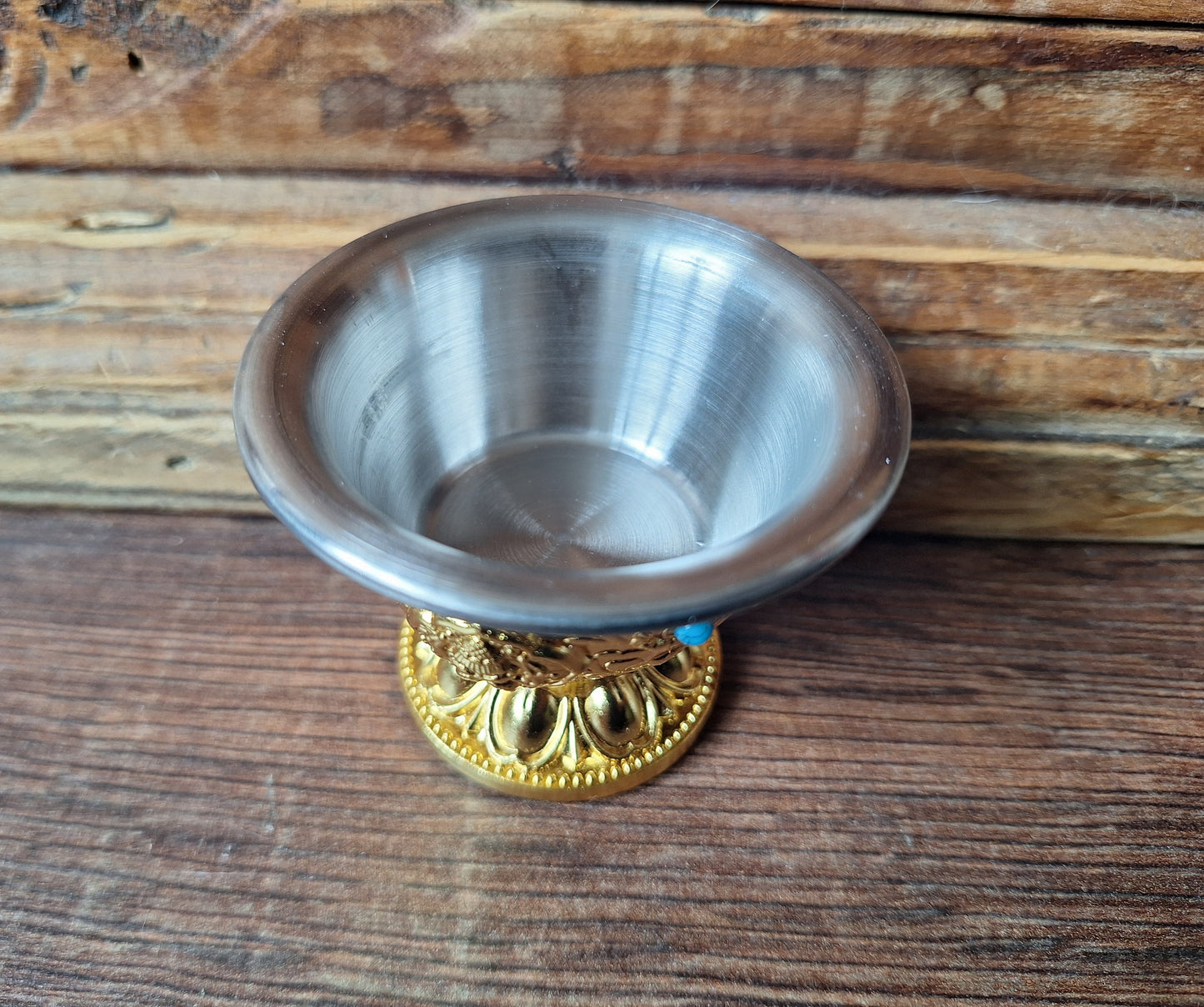 Gold coloured metal alloy offering bowl