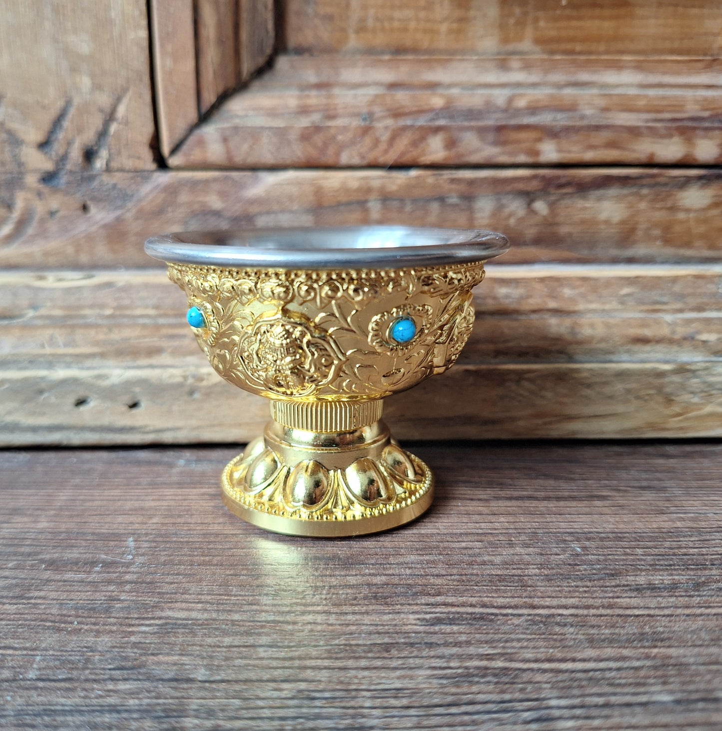 Gold coloured metal alloy offering bowl