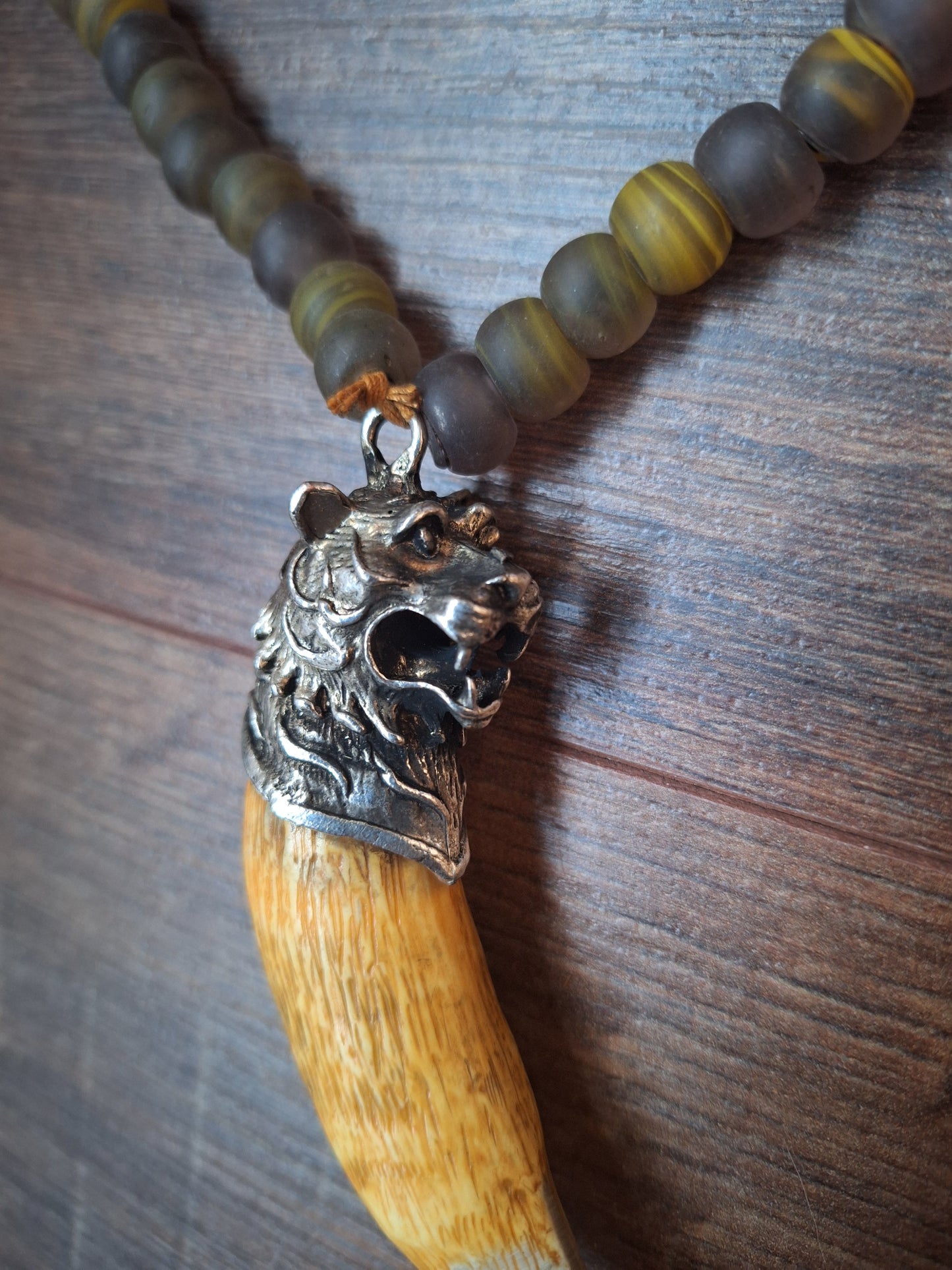 Vintage glass bead necklace with resin tiger tooth pendant