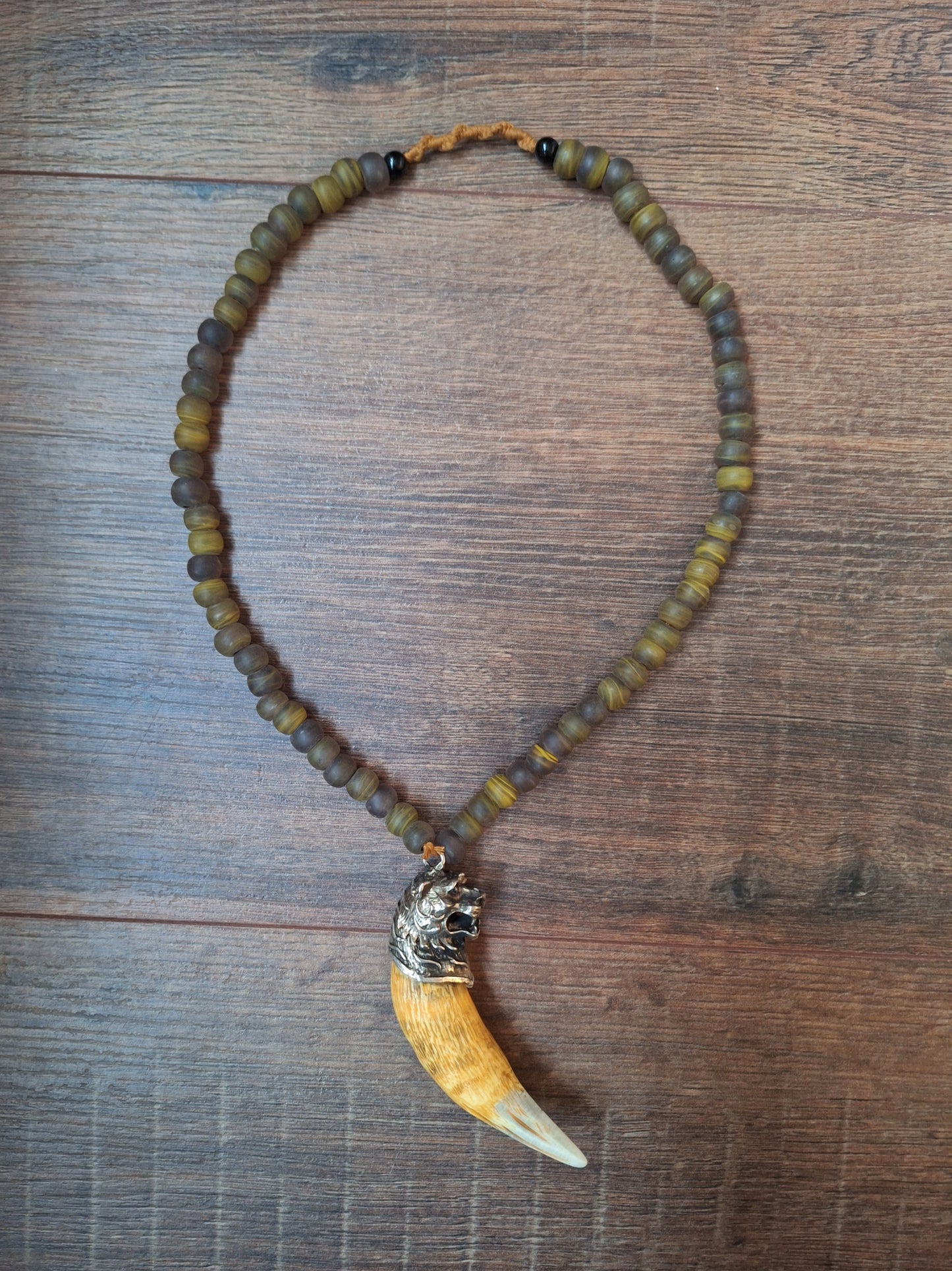 Vintage glass bead necklace with resin tiger tooth pendant