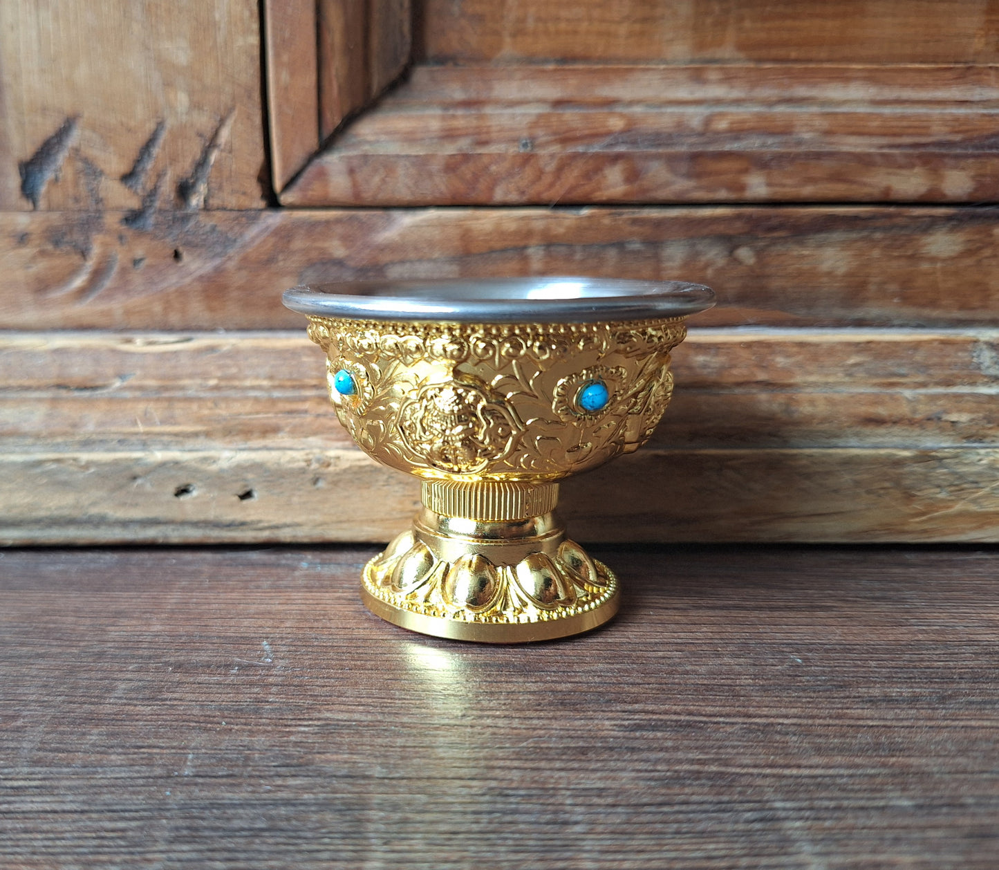 Gold coloured metal alloy offering bowl