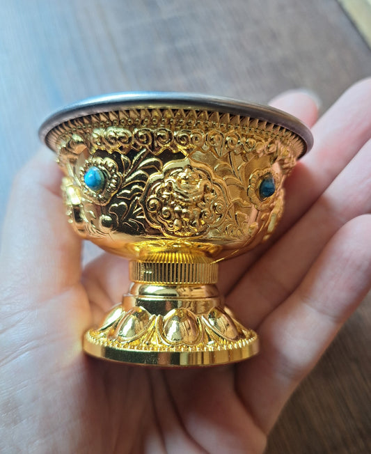 Gold coloured metal alloy offering bowl