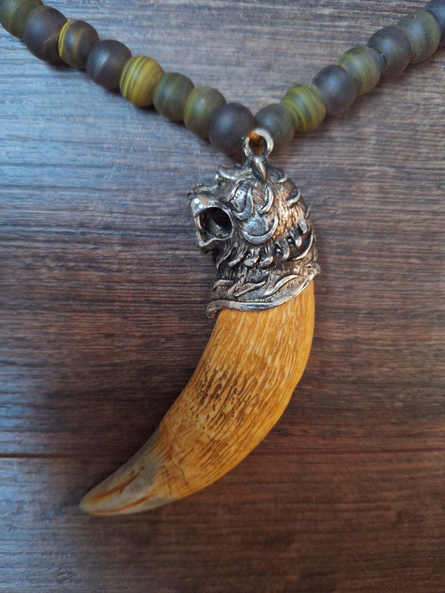 Vintage glass bead necklace with resin tiger tooth pendant
