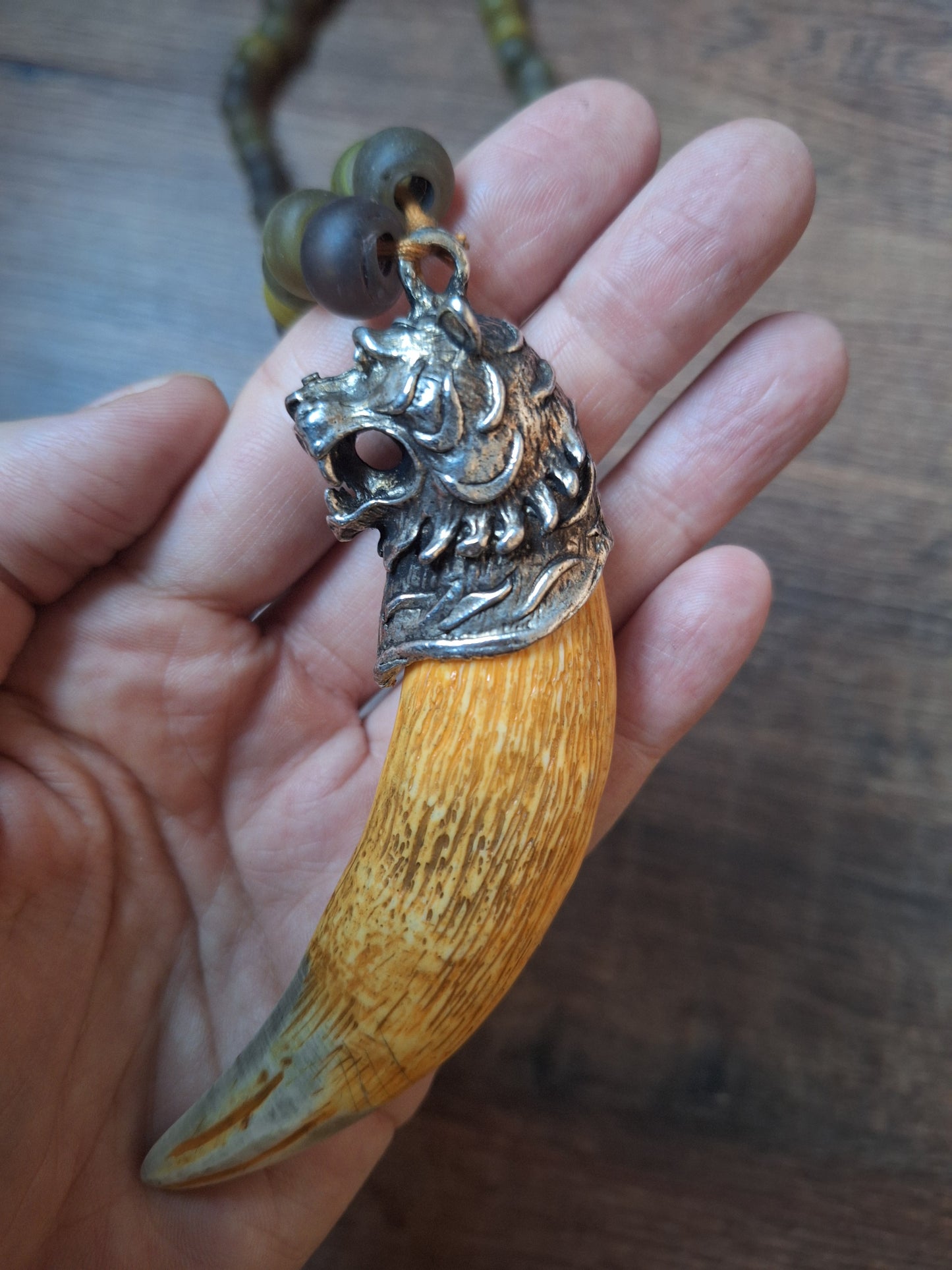 Vintage glass bead necklace with resin tiger tooth pendant