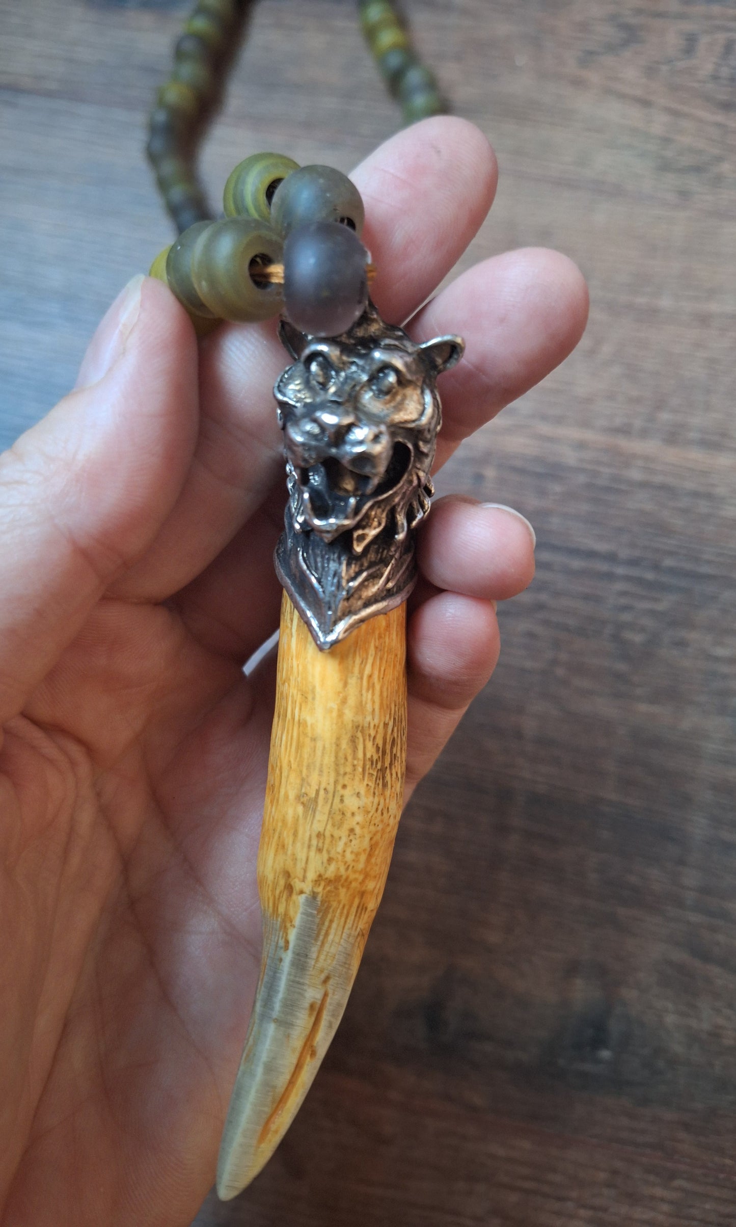 Vintage glass bead necklace with resin tiger tooth pendant