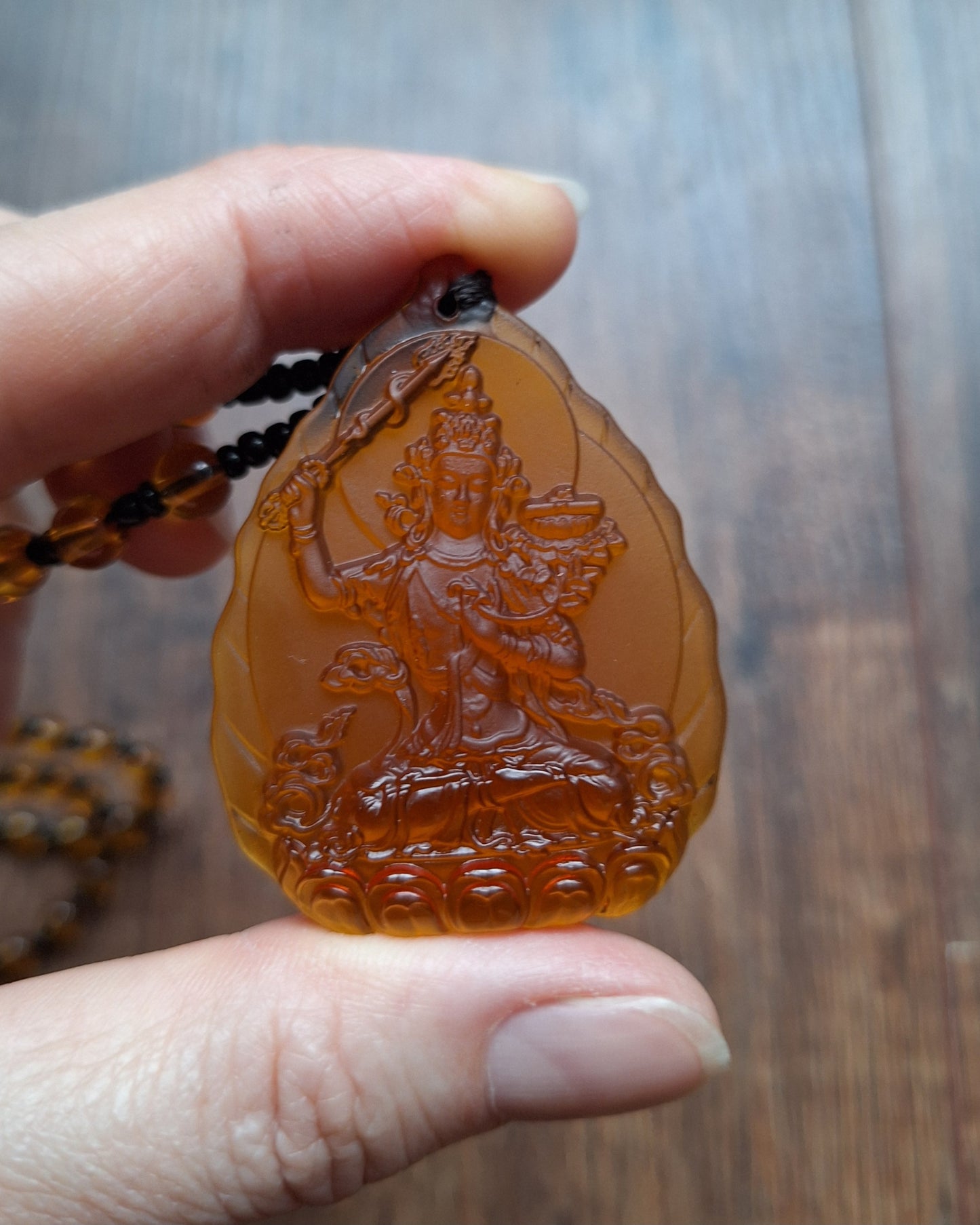 Orange glass necklace with Manjushri pendant