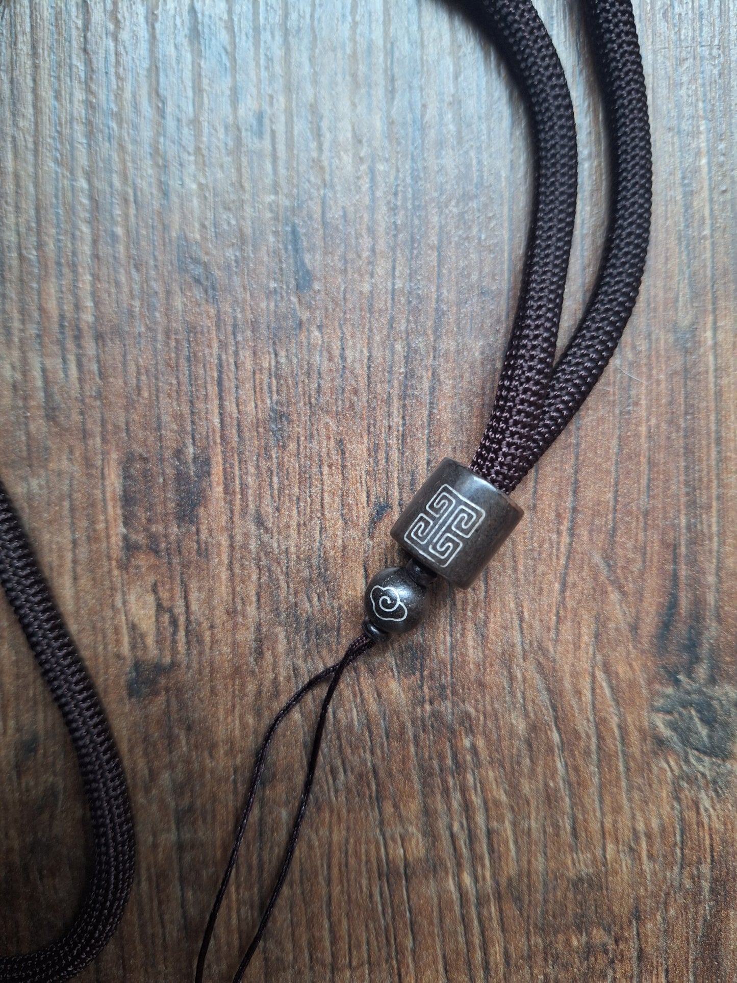 Amulet cord brown with shou symbol