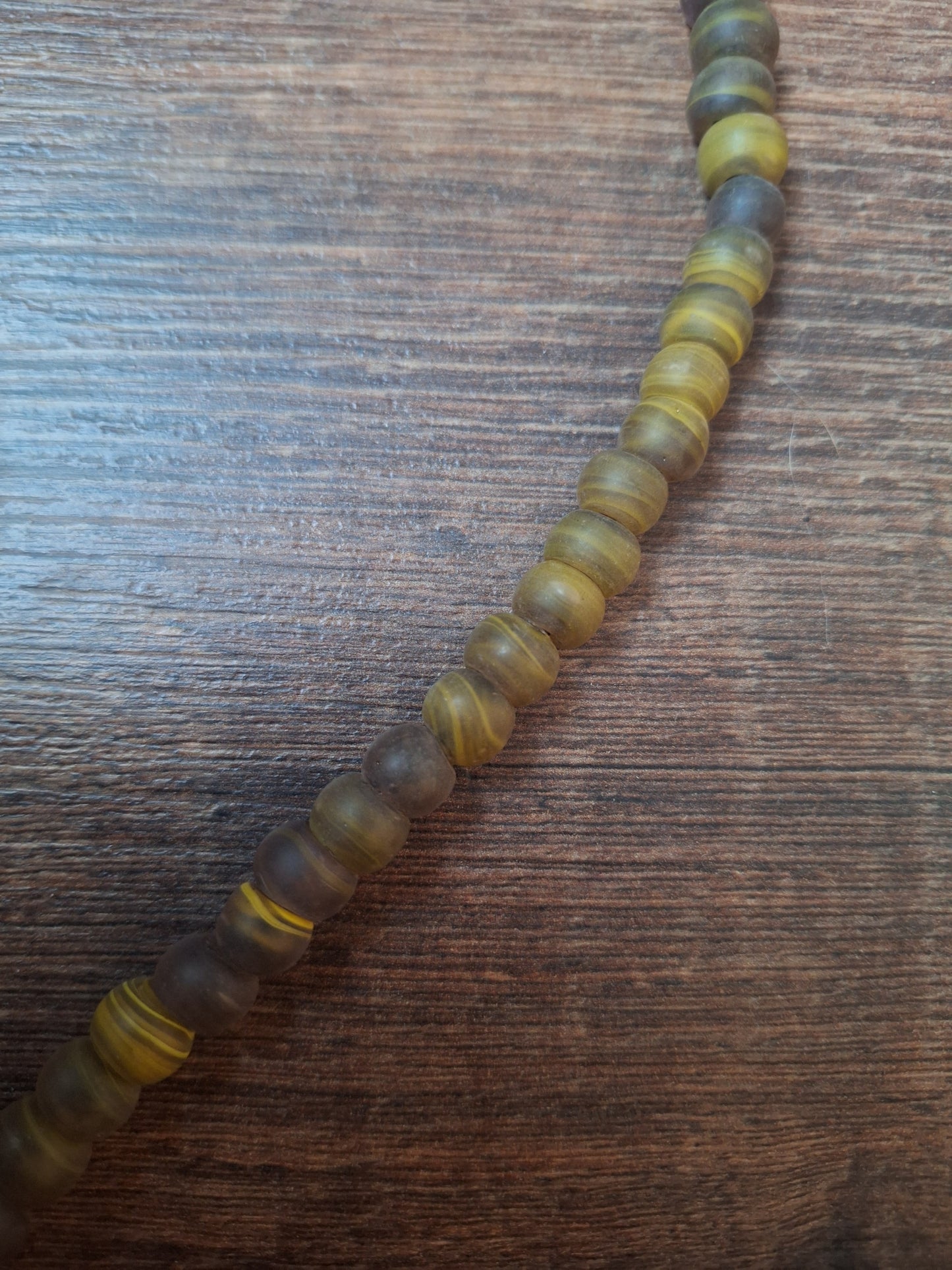 Vintage glass bead necklace with resin tiger tooth pendant