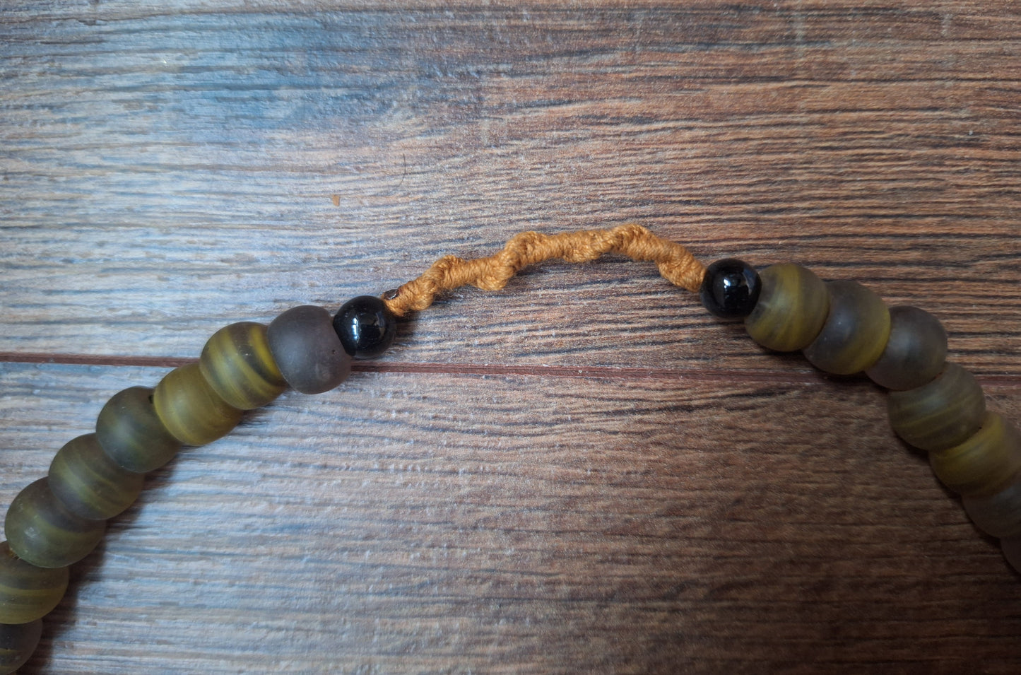 Vintage glass bead necklace with resin tiger tooth pendant