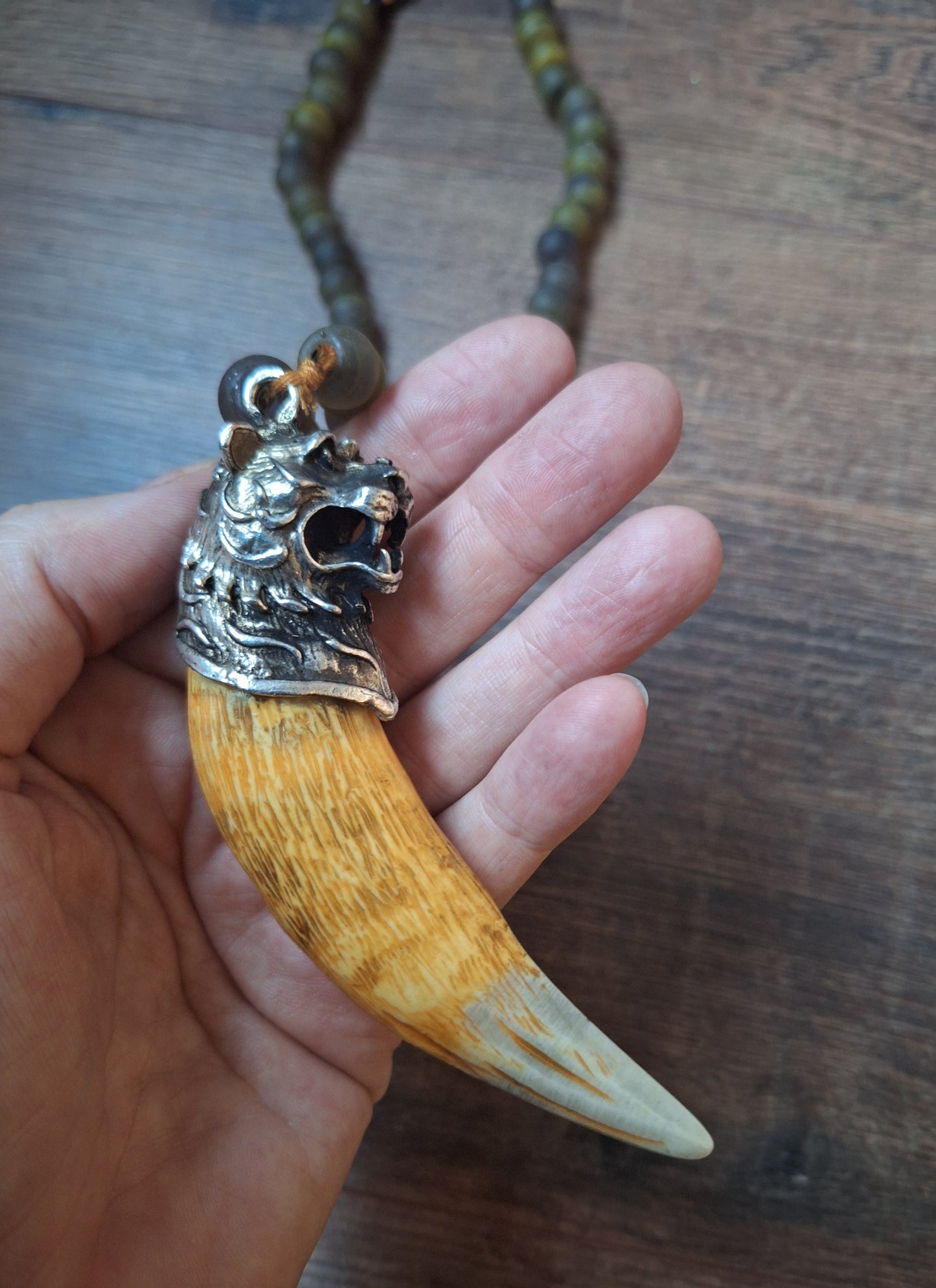 Vintage glass bead necklace with resin tiger tooth pendant
