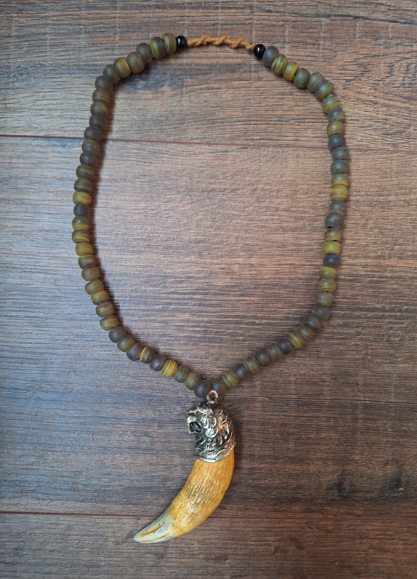 Vintage glass bead necklace with resin tiger tooth pendant